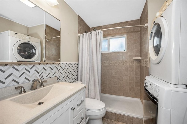 5 Dirlam Cir, Tewksbury, MA 01876 - full bathroom with stacked washer and clothes dryer, a tile shower, toilet, tile walls, and vanity
