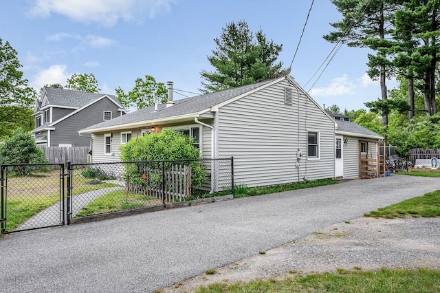 5 Dirlam Cir, Tewksbury, MA 01876 - view of side of home with a gate and a shingled roof