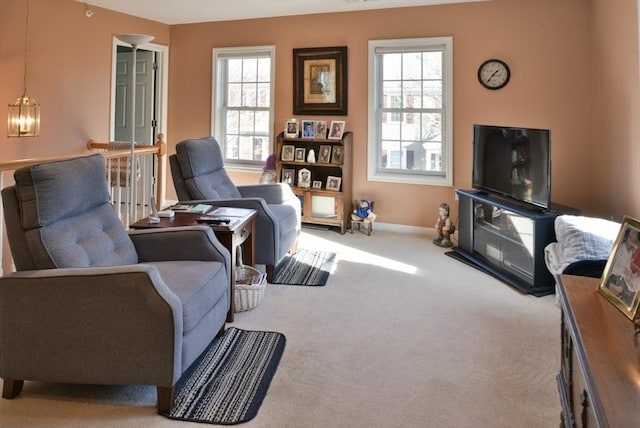 living room with plenty of natural light and light carpet