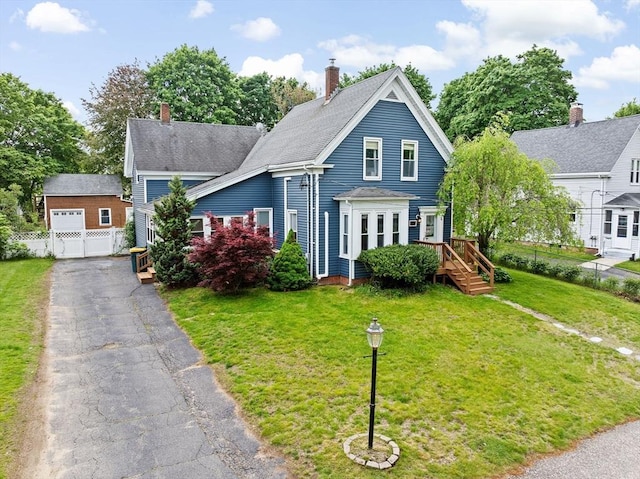 30 Highland St, Abington, MA 02351 - view of front of home with a chimney, an outbuilding, a garage, and a wooden deck