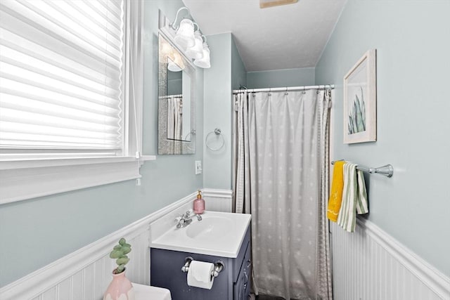 30 Highland St, Abington, MA 02351 - full bathroom featuring wainscoting, vanity, a decorative wall, and curtained shower