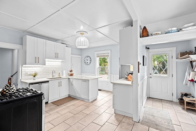 30 Highland St, Abington, MA 02351 - kitchen featuring a sink, stainless steel dishwasher, light countertops, a peninsula, and white cabinets