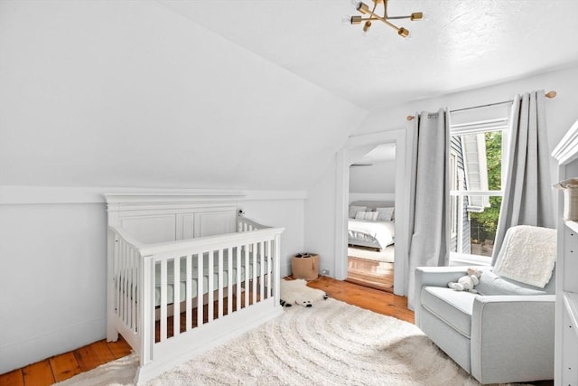 30 Highland St, Abington, MA 02351 - bedroom with wood finished floors, vaulted ceiling, a nursery area, and a chandelier