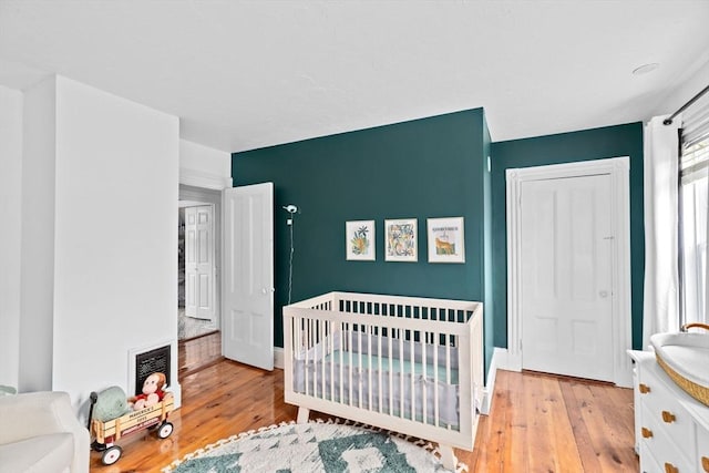 30 Highland St, Abington, MA 02351 - bedroom featuring hardwood / wood-style floors, a sink, a nursery area, and baseboards