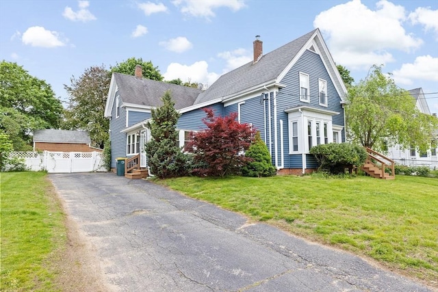 30 Highland St, Abington, MA 02351 - view of front of property with a chimney, entry steps, a detached garage, and roof with shingles