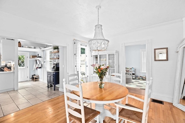 30 Highland St, Abington, MA 02351 - dining space with a chandelier, light wood-style floors, ornamental molding, and baseboards
