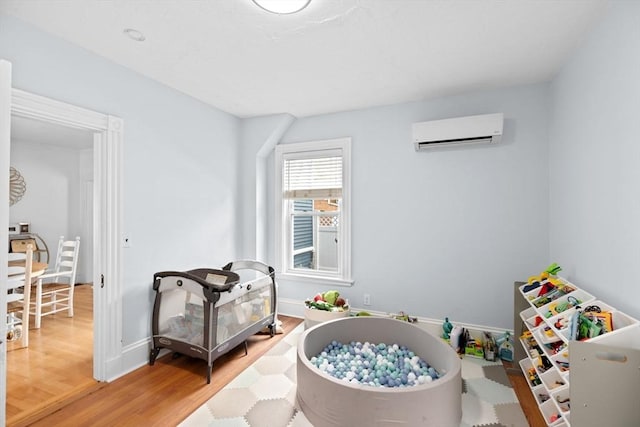 30 Highland St, Abington, MA 02351 - game room with a wall unit AC, light wood-style floors, and baseboards