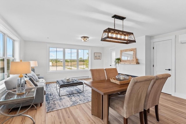 30 Cable Ave Unit B, Salisbury, MA 01952 - dining room featuring light wood-style floors and a wall mounted air conditioner