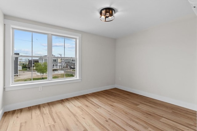 30 Cable Ave Unit B, Salisbury, MA 01952 - empty room featuring light wood-style floors and a chandelier