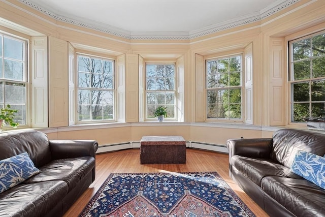 sunroom featuring a baseboard heating unit
