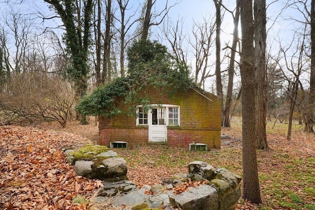 view of property exterior with brick siding