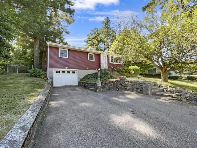 view of front facade featuring a front yard and a garage