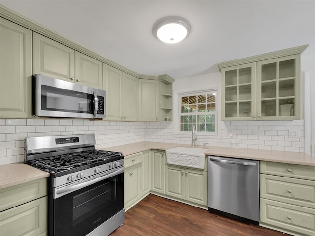 kitchen featuring backsplash, dark hardwood / wood-style flooring, sink, and appliances with stainless steel finishes