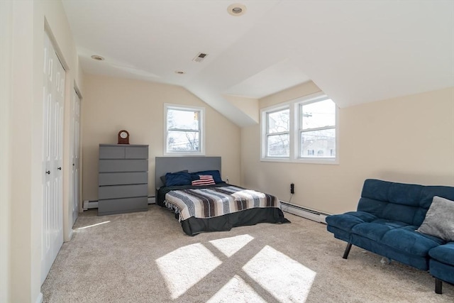 carpeted bedroom featuring visible vents, a baseboard heating unit, a closet, lofted ceiling, and baseboard heating