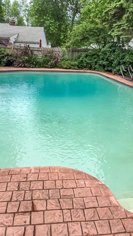 view of swimming pool with a fenced in pool and fence