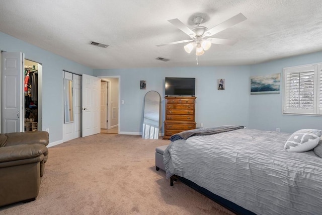 bedroom featuring ceiling fan, carpet flooring, visible vents, and baseboards