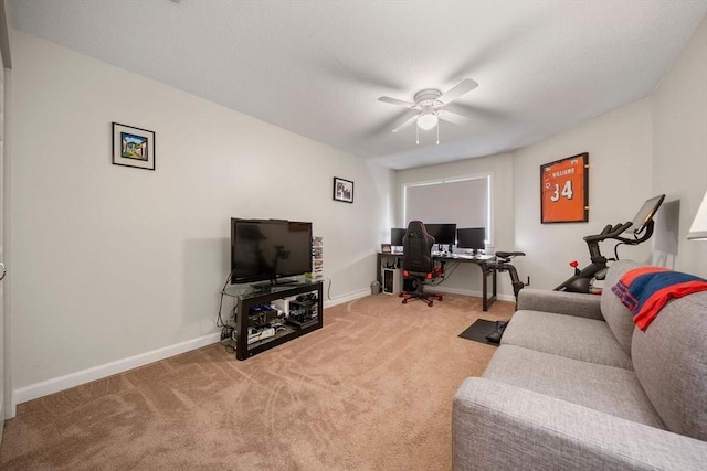 carpeted living room with baseboards and a ceiling fan