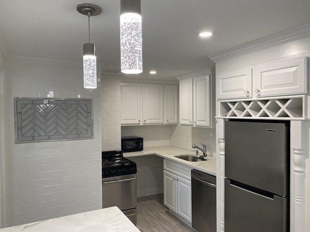 210 Hillside Ave Unit 37, Needham, MA 02494 - kitchen with appliances with stainless steel finishes, ornamental molding, white cabinets, light wood finished floors, and decorative light fixtures