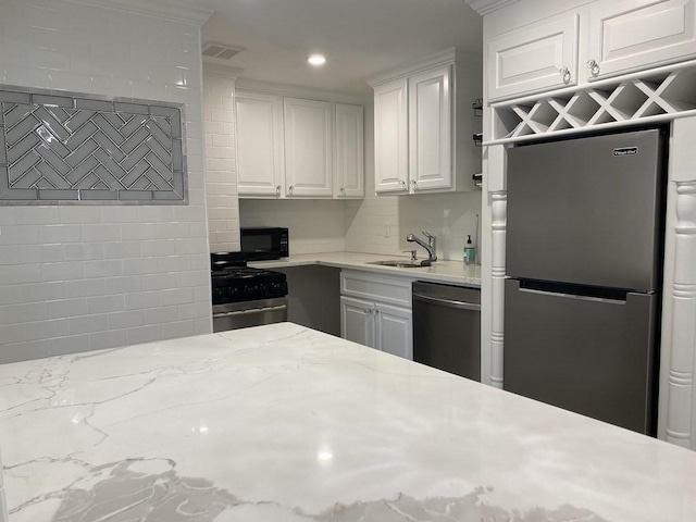 210 Hillside Ave Unit 37, Needham, MA 02494 - kitchen featuring appliances with stainless steel finishes, white cabinets, recessed lighting, backsplash, and light stone countertops