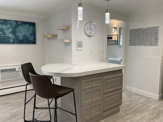 210 Hillside Ave Unit 37, Needham, MA 02494 - kitchen with gray cabinetry, light wood-style flooring, a wall mounted AC, ornamental molding, and a breakfast bar
