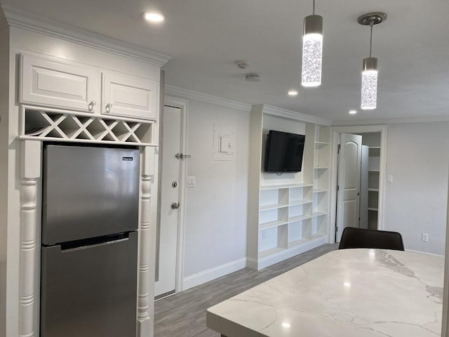 210 Hillside Ave Unit 37, Needham, MA 02494 - kitchen featuring freestanding refrigerator, light wood-style flooring, crown molding, white cabinetry, and light stone counters