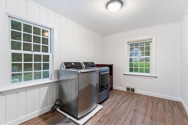 laundry area featuring washer and clothes dryer and hardwood / wood-style floors