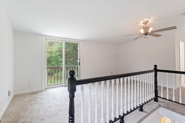 interior space with ceiling fan and carpet flooring