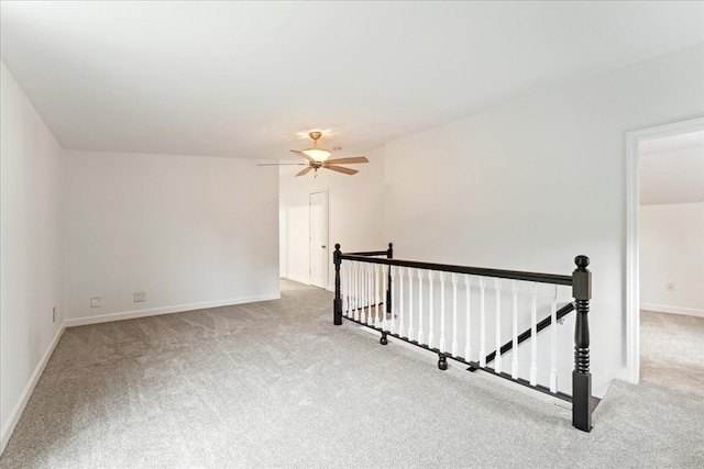 spare room featuring ceiling fan and light carpet