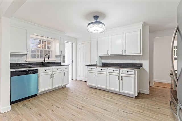 kitchen with stainless steel dishwasher, tasteful backsplash, white cabinets, sink, and light hardwood / wood-style flooring