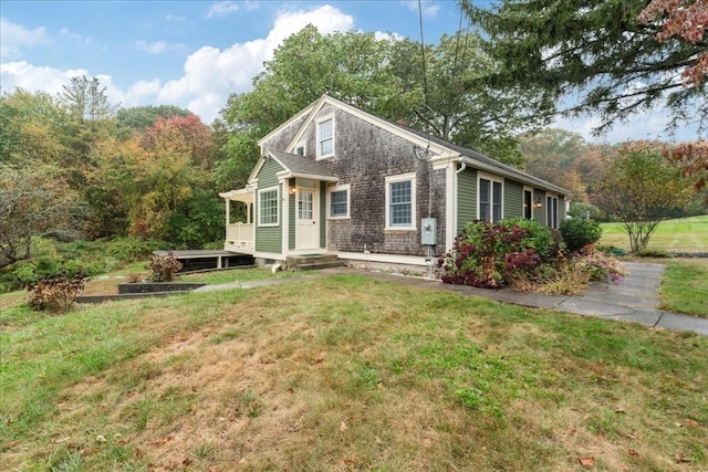 view of front of property featuring a deck and a front lawn