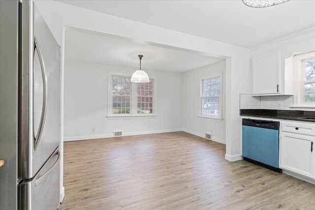 kitchen with appliances with stainless steel finishes, light wood-type flooring, and white cabinetry