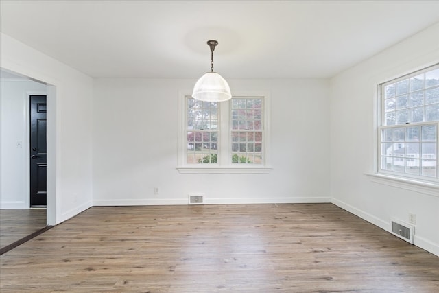 unfurnished dining area with light hardwood / wood-style floors