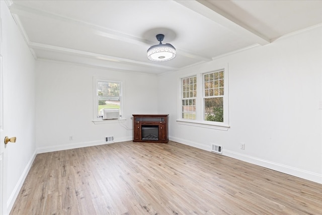 unfurnished living room featuring light wood-type flooring, crown molding, and beam ceiling