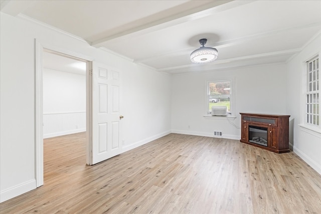 unfurnished living room featuring beamed ceiling, crown molding, and light hardwood / wood-style floors