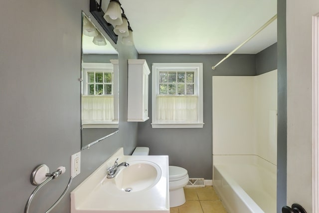 full bathroom with vanity, toilet, tile patterned floors, and shower / bathing tub combination