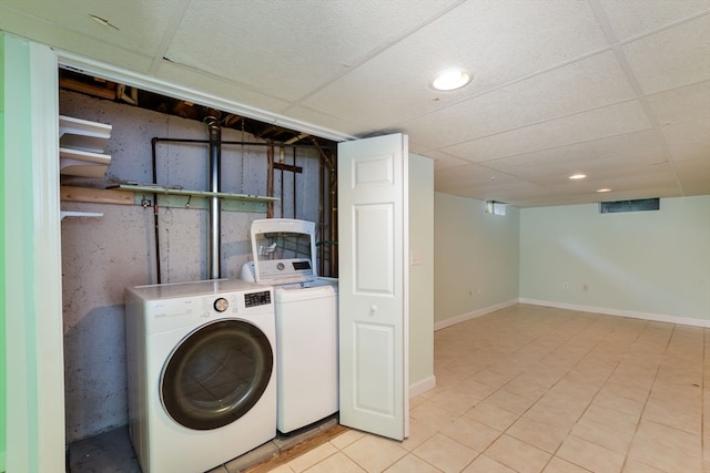 washroom featuring washer and clothes dryer and light tile patterned flooring