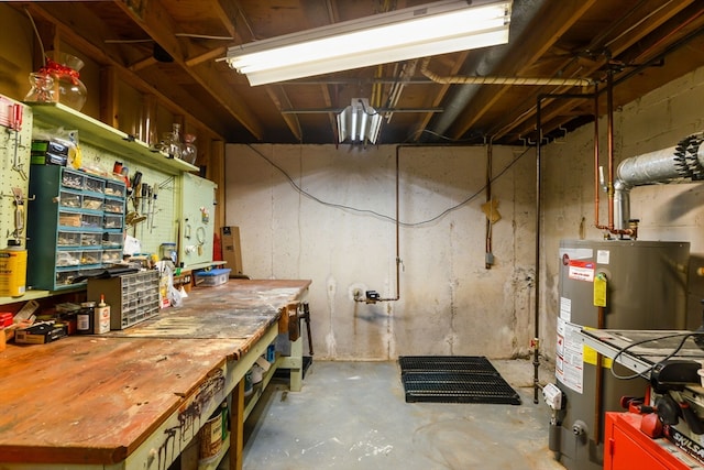 basement featuring gas water heater and a workshop area