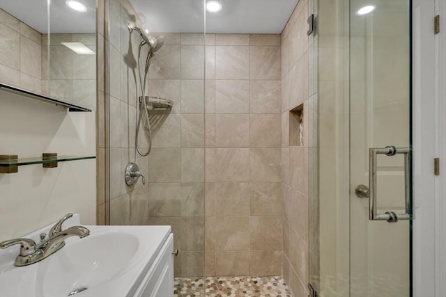 bathroom with an enclosed shower and vanity