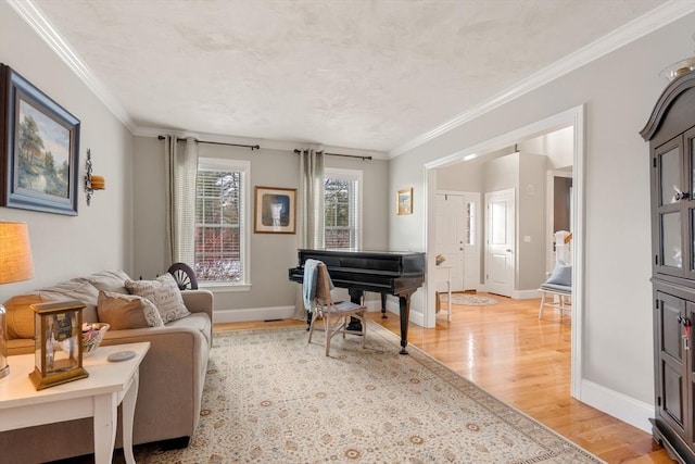 living area featuring ornamental molding and light hardwood / wood-style floors