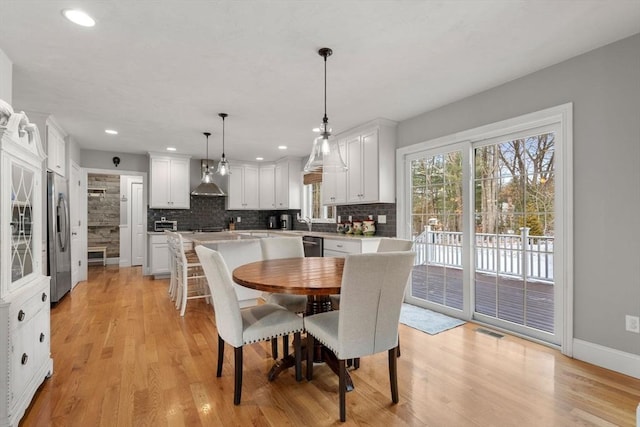 dining space with light wood-type flooring