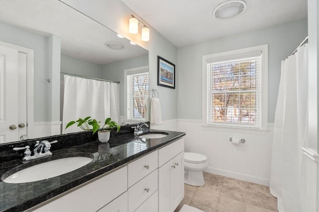 bathroom with tile patterned floors, vanity, and toilet