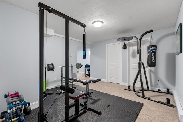 exercise area with carpet flooring and a textured ceiling