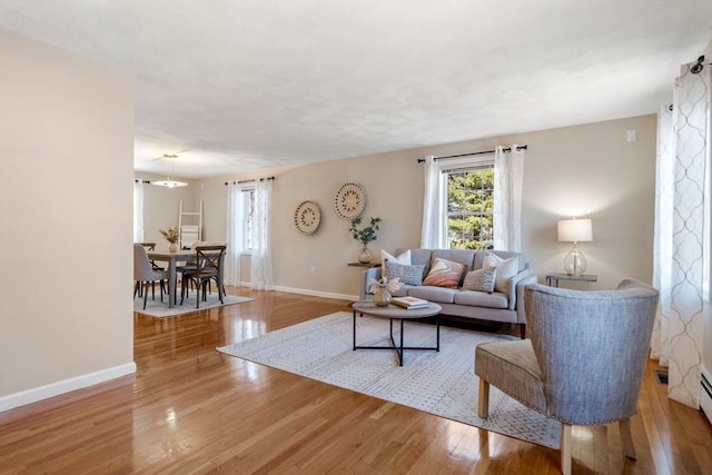 living room featuring wood finished floors and baseboards