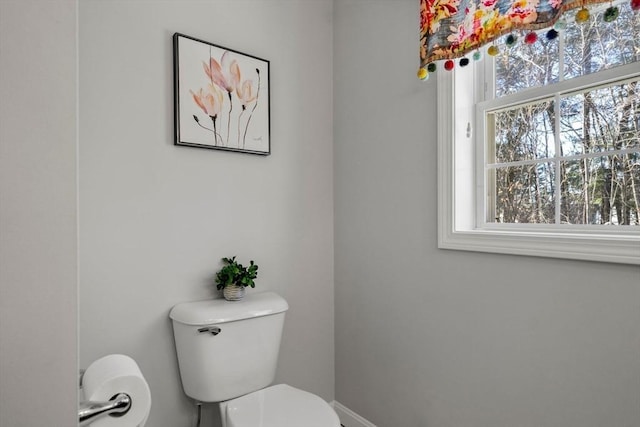 half bath featuring toilet and plenty of natural light