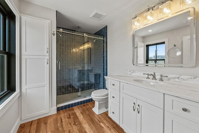 70 W Vine St, Provincetown, MA 02657 - bathroom with a stall shower, vanity, wood finished floors, and toilet
