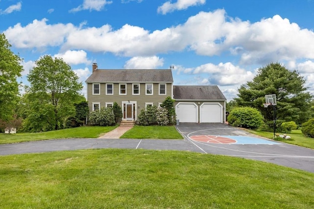 25 Piasta Rd, Dudley, MA 01571 - colonial inspired home featuring a chimney, an attached garage, a front lawn, and asphalt driveway