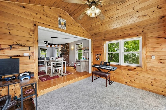 25 Piasta Rd, Dudley, MA 01571 - interior space with ceiling fan, wood walls, vaulted ceiling, healthy amount of natural light, and carpet flooring