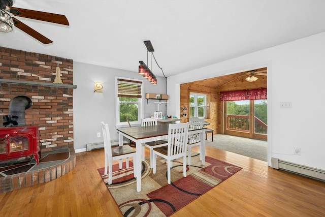 25 Piasta Rd, Dudley, MA 01571 - dining space featuring ceiling fan, a wood stove, wood finished floors, plenty of natural light, and vaulted ceiling