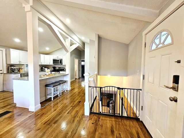 20 Upland Rd, Marlborough, MA 01752 - entryway featuring vaulted ceiling, wood finished floors, and recessed lighting