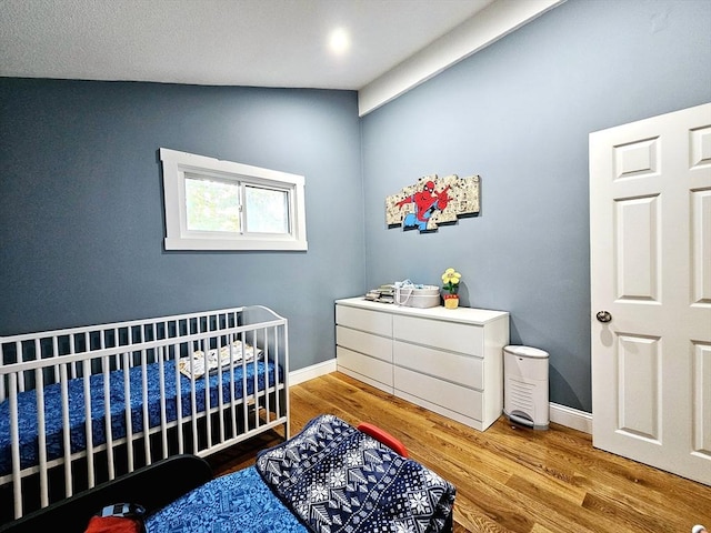 20 Upland Rd, Marlborough, MA 01752 - bedroom featuring a crib and wood finished floors